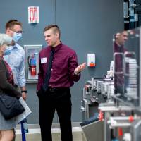 Student demonstrates project to guests